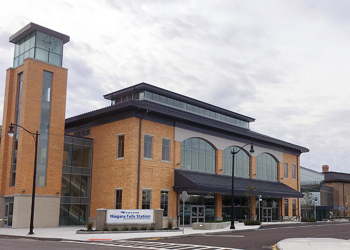 Niagara Falls, NY, station, which is constructed of buff brick with large windows.