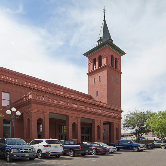 The El Paso station features a clock tower with pyramidal roof.