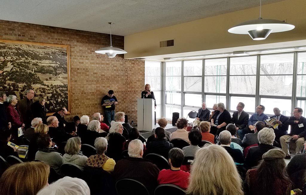 A crowd listens to Lawrence Assistant City Manager Diane Stoddard.