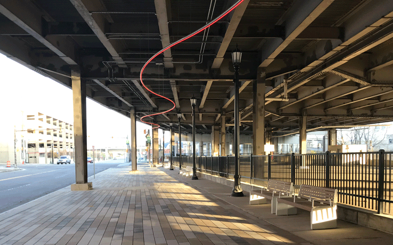 Underside of a highway with LED lighting attached.