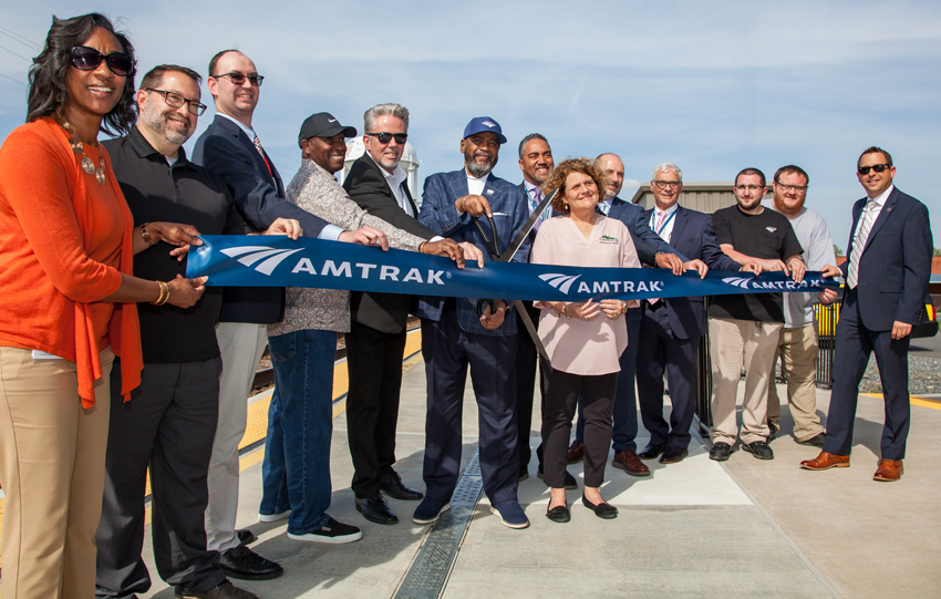 A group cuts a ceremonial ribbon