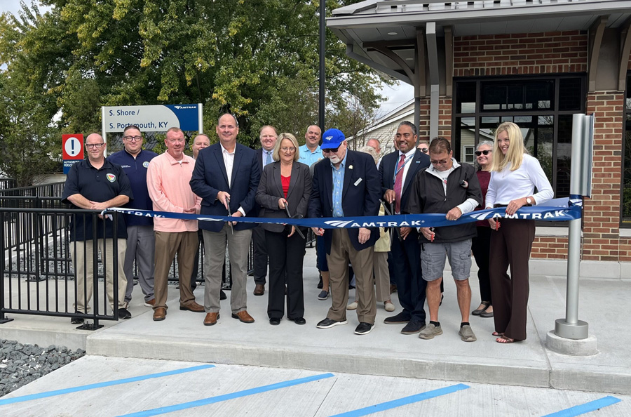 A crowd cuts a ribbon at the South Shore, Kentucky, station.