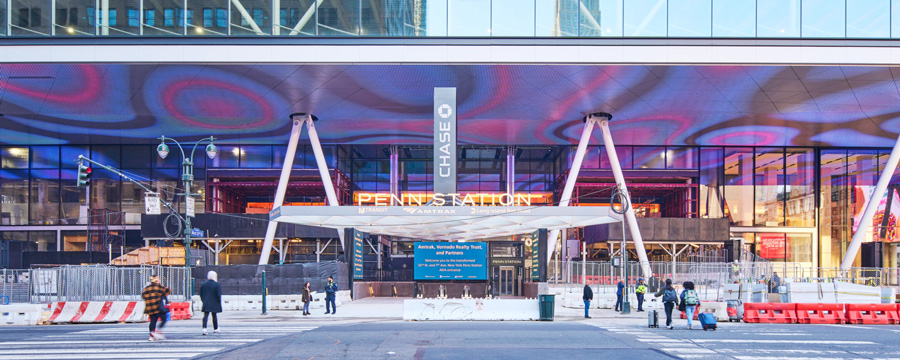 An entrance to a train station that includes a canopy