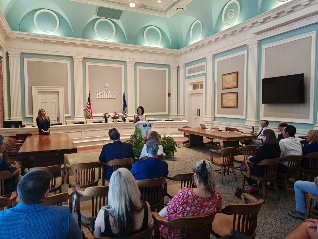 A woman speaks at a podium