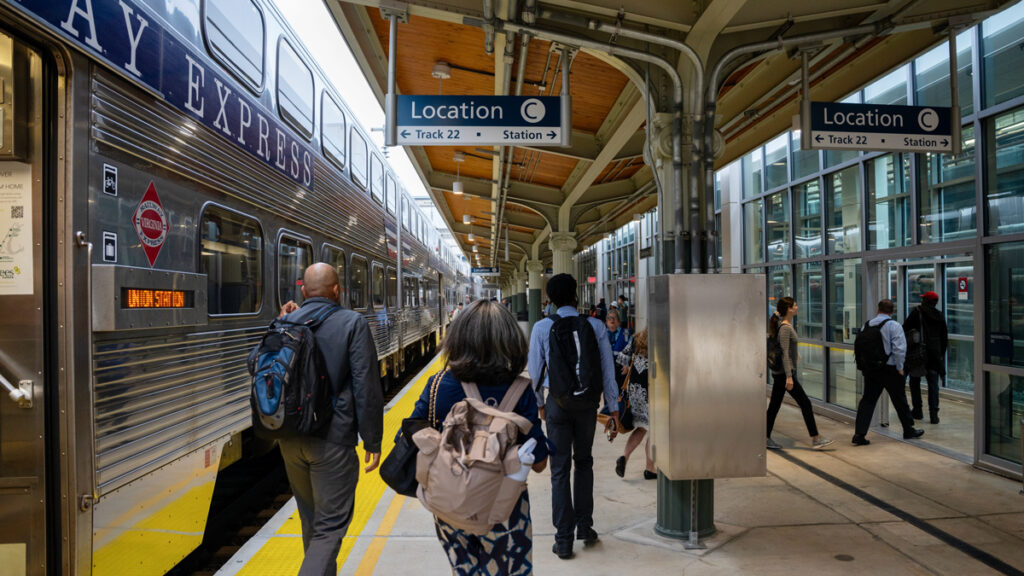 Passengers exit a train on a platform