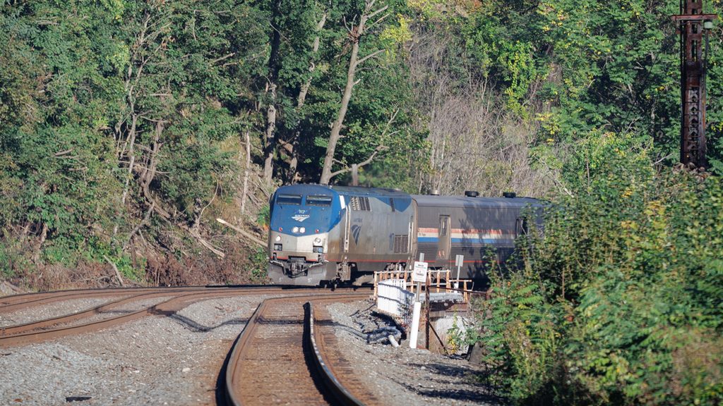 The Pennsylvanian rounds a curve in a wooded area.