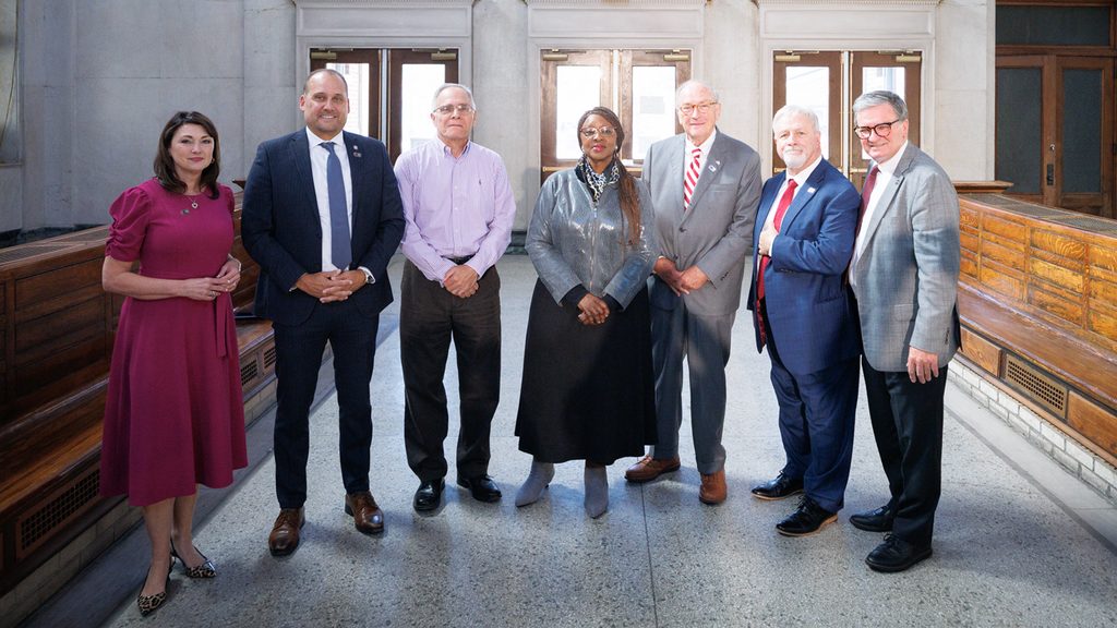 State, local and Amtrak officials gather for a group photo.